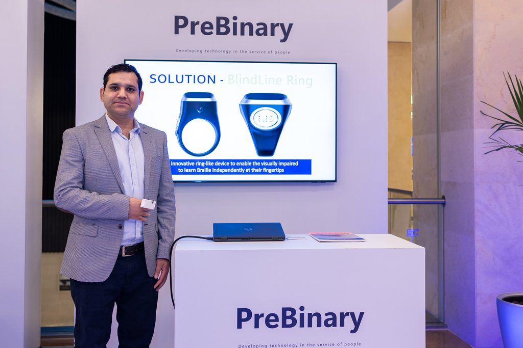 BlindLine Ring, a ring-like device that helps visually impaired people learn Braille, shown on screen at the PreBinary stand